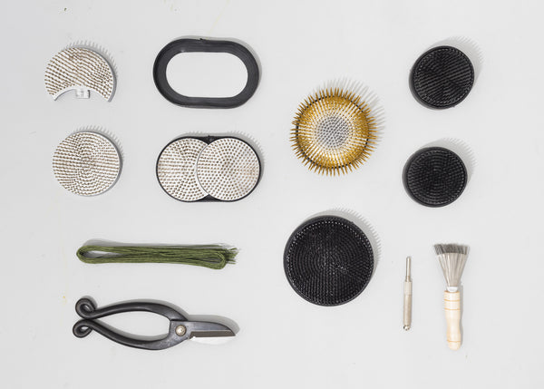 Different varieties of kenzan and ikebana tools