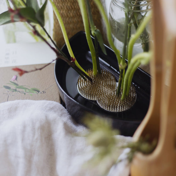 Sun and moon kenzan in a half moon vase